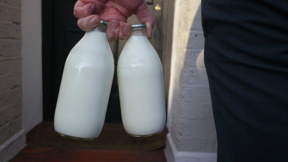 milk bottles being delivered to door by milkman