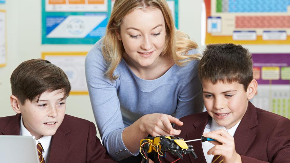 Teacher with two pupils in a classroom