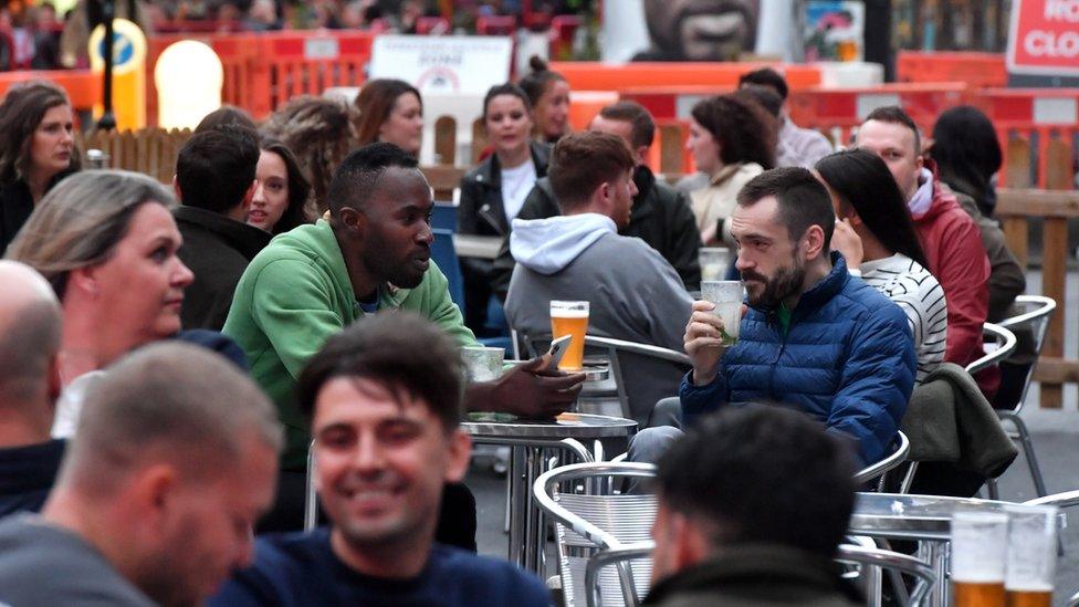 Bars on Hilton Street in Manchester's Northern Quarter set out tables for customers