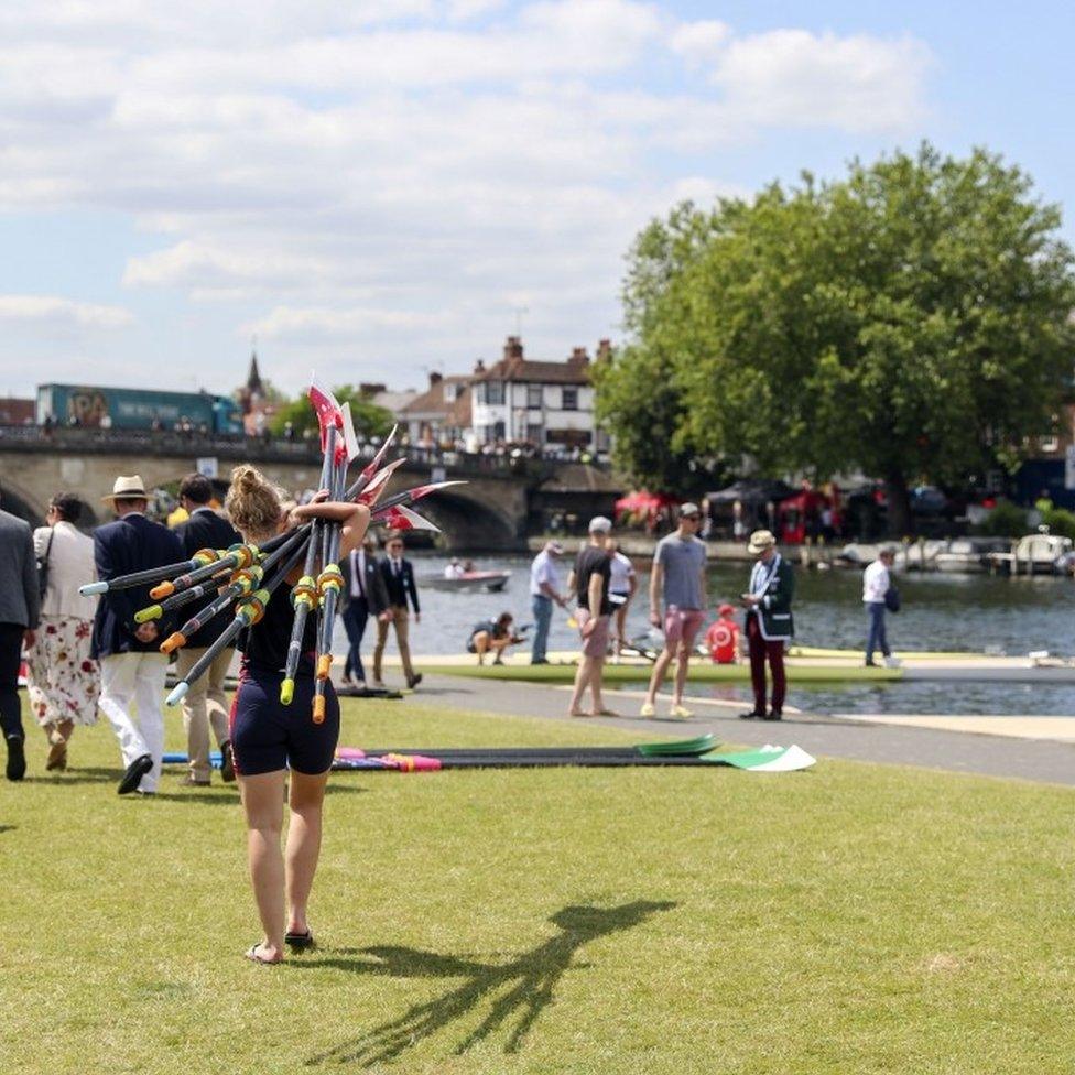 Rower carrying oars