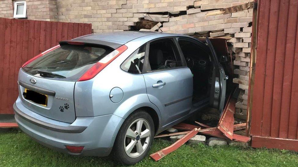 Car crashed into house