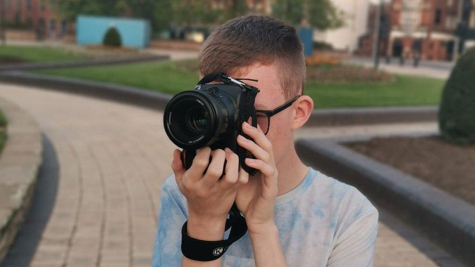 Callum Utley taking a photo with a digital SLR camera