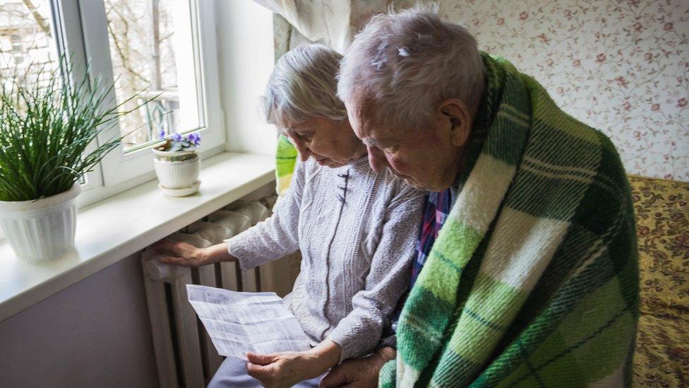 Elderly couple look at heating bill