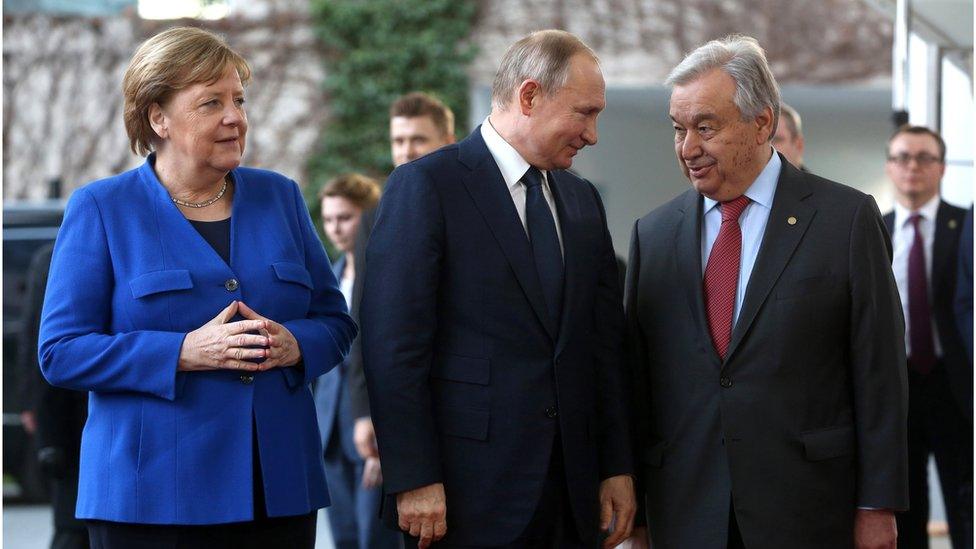 German Chancellor Angela Merkel, Russian President Vladimir Putin and United Nations Secretary-General Antonio Guterres arrive for an international summit on securing peace in Libya, held in Germany