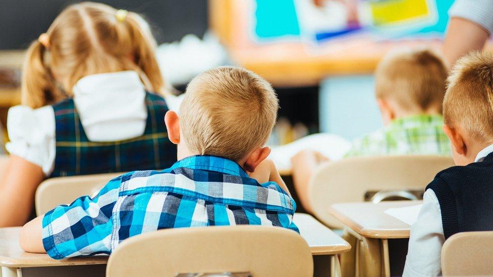 Boy sits in classroom