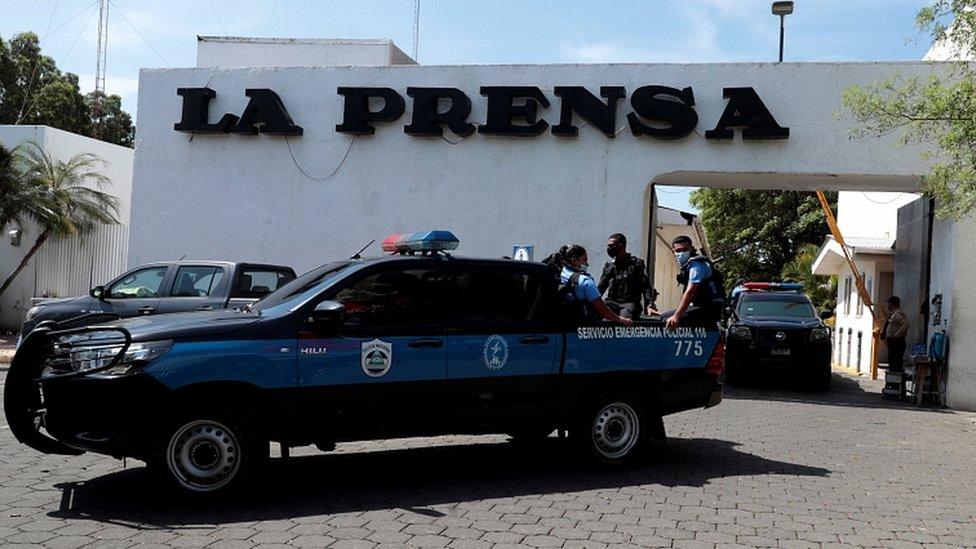 Police at the entrance of a property owned by La Prensa during a search operation, in Managua, Nicaragua, 13 August 2021