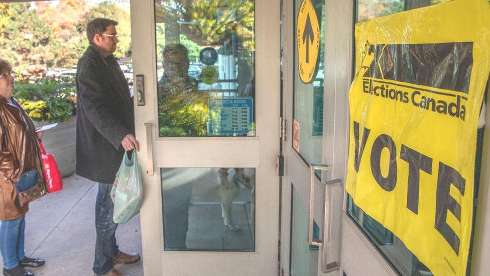 People line up to vote at a polling station at Trinity Community Rec Center for Canada's 43rd general election October 21, 2019