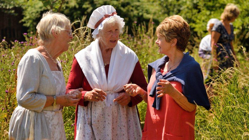 Volunteer costumed interpreters in the garden at Coleridge Cottage