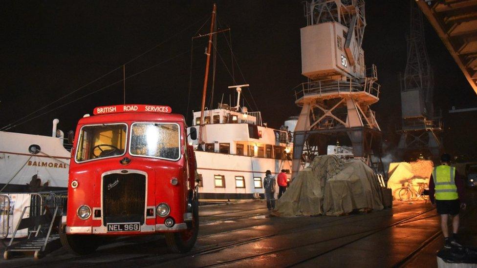 Image of Princes Wharf. It was turned into Port Royal Harbour in Jamaica for filming. A red vintage bus can be seen, as well as MV Balmoral.