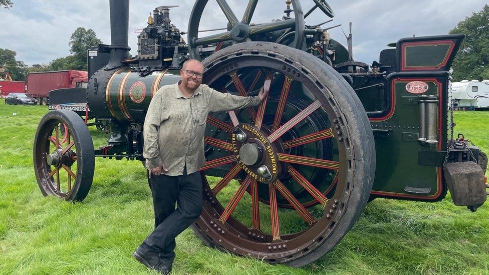 Man stood in front of a steam engine