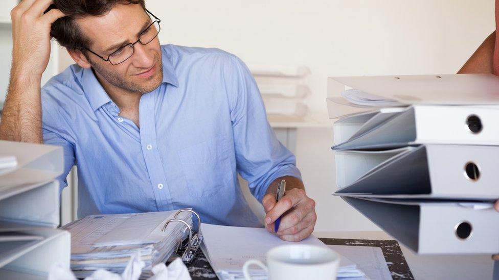 Man working at messy desk