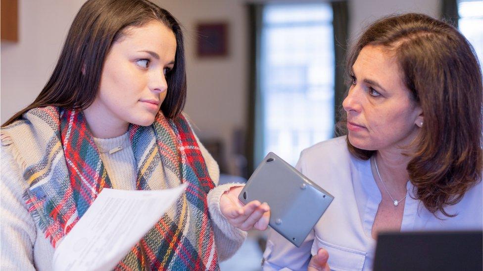 A young woman and mother debate finances