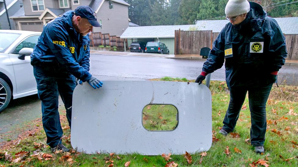 National Transportation Safety Board agents with the recovered door plug