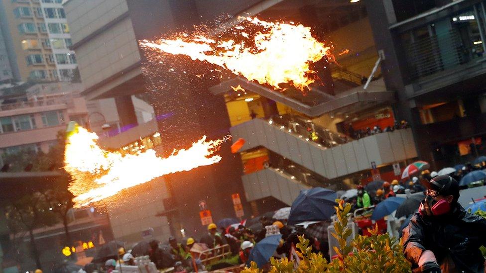 An anti-extradition bill protester throws a Molotov cocktail