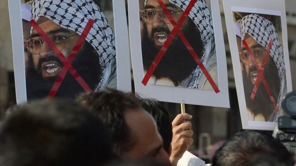 Indian activists carry placards of the chief of Jaish-e-Mohammad, Maulana Masood Azhar during a protest against the attack on the air force base in Pathankot, in Mumbai on January 4, 2016