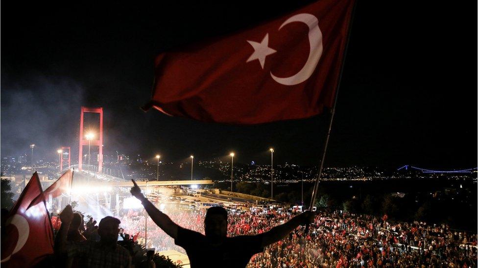 Citizens wave Turkish Flags during a march towards Bosphorus Bridge to protest failed military coup attempt and to show solidarity with the Turkish government in Istanbul.