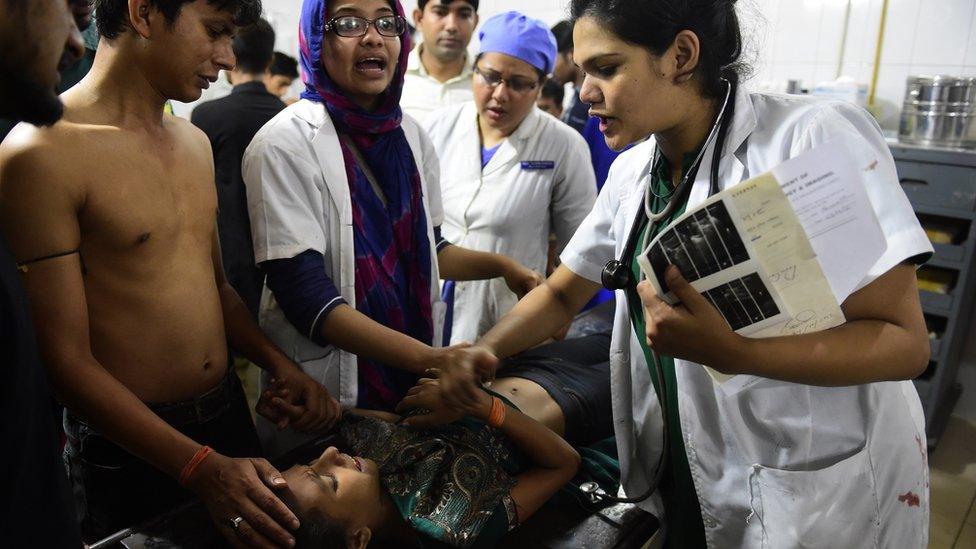 Doctors attend to a little girl in Dhaka medical college hospital after a small bomb exploded outside the Bangladesh capital's main Shia religious site in Dhaka on October 24, 2015