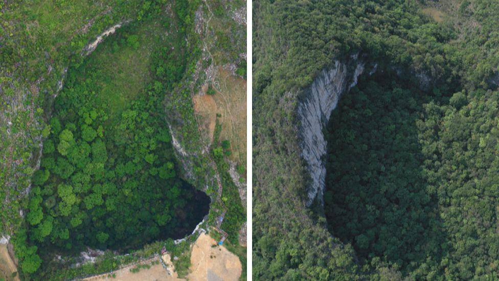 Aerial photos of two sinkholes in China's Guangxi province showing a sinkhole dropping away in the middle of the forest. Trees are growing everywhere - on the top of the cliffs as well as at the bottom of the oval-shaped hole. 