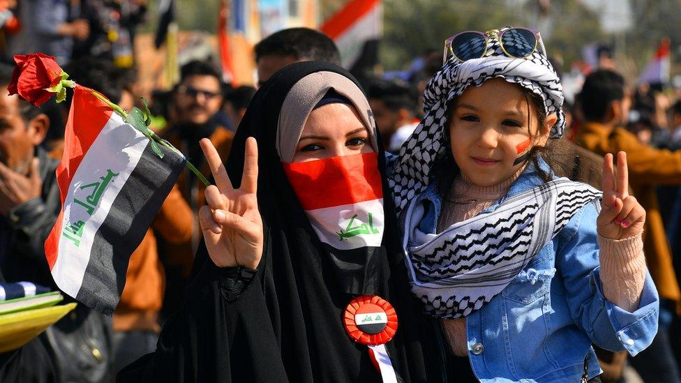 An Iraqi woman and a child take part in anti-government protests in Najaf, 28 January