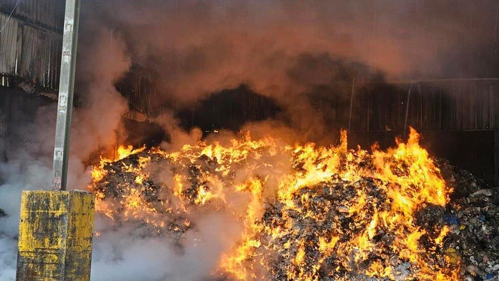 Flaming piles of waste inside the warehouse