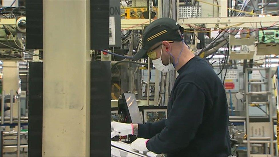 Toyota worker wearing a face mask and gloves