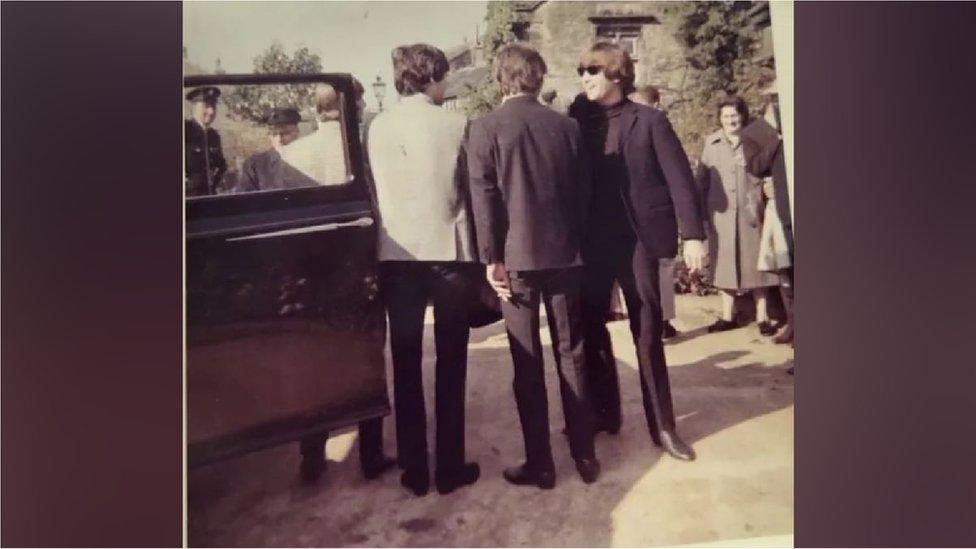 The Beatles get into a car at Holdsworth House