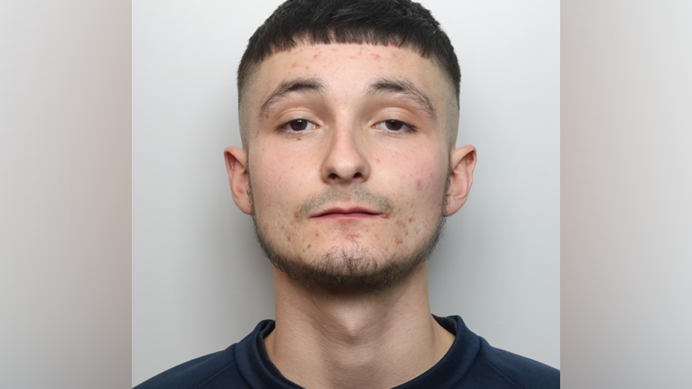 Police mugshot of Tyler Marchese wearing a dark jumper