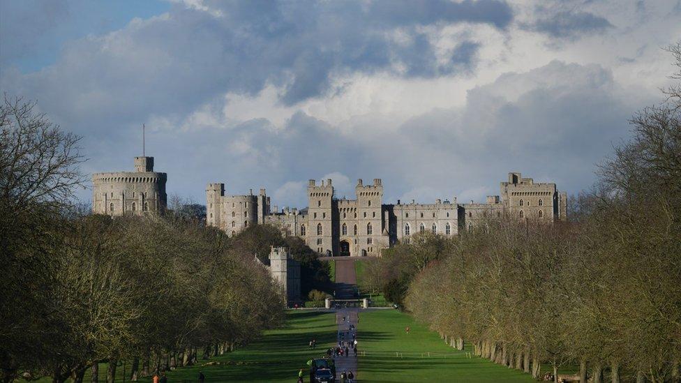 The tree-lined avenue of The Long Walk in Windsor Great Park with the castle in the background