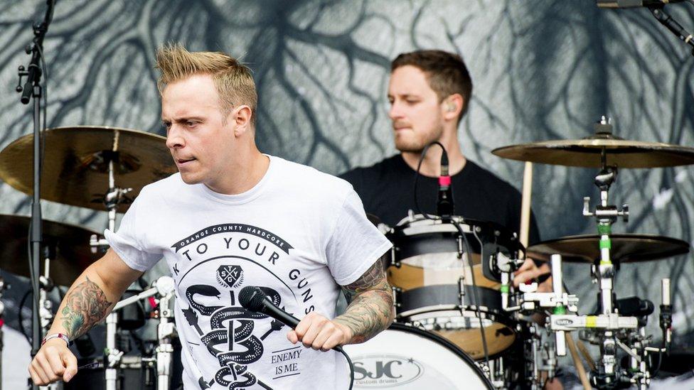 Drummer Dan Searle on stage with singer Sam Carter at Download Festival in 2013