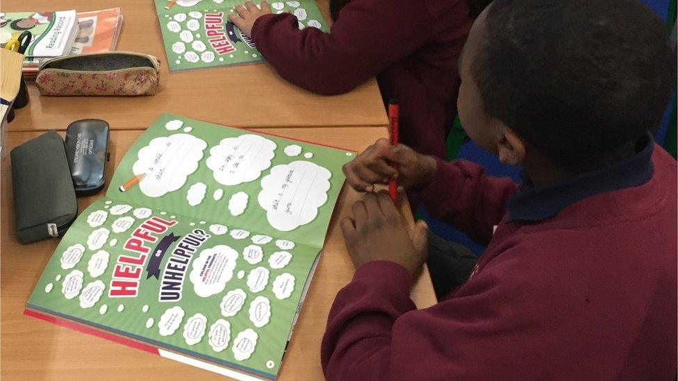 Child filling in their workbook