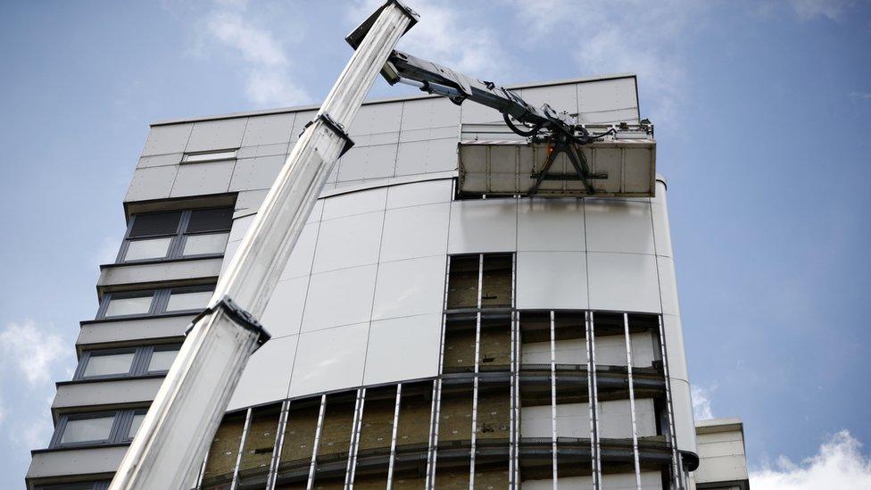 Cladding being removed from a tower block