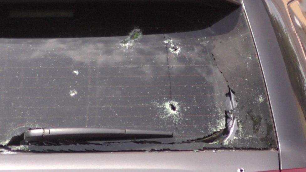 Bullet holes in the window of a vehicle