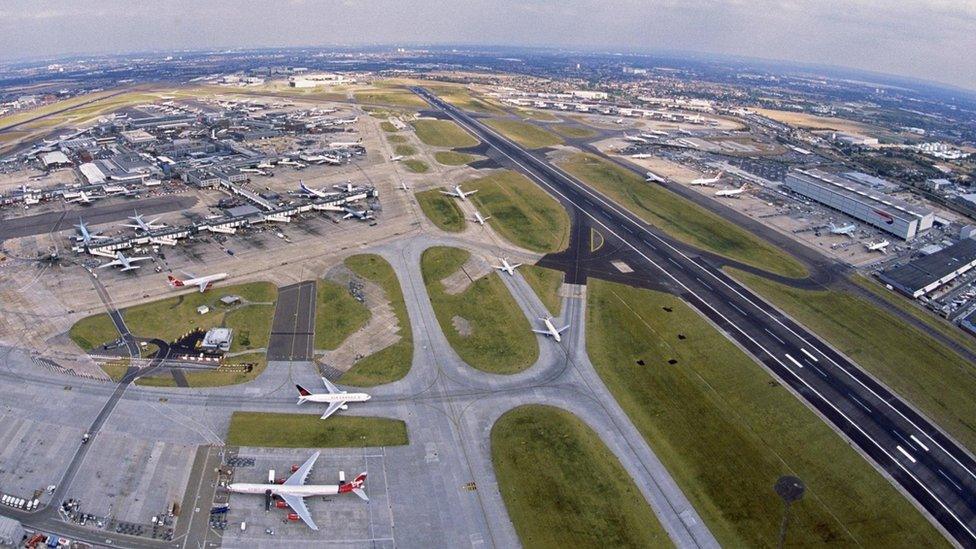 aerial view of the southern runway with Terminals 1, 2 and 3 (left) and cargo terminal (right).