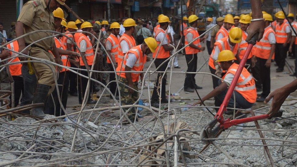 Indian rescue workers try to free people trapped under the wreckage of a collapsed flyover bridge in Kolkata on April 1, 2016.