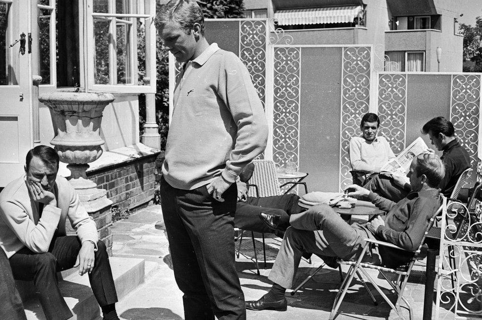 Jimmy Greaves (left) accepts the commiserations of his team mates on 21 July 1966 after being dropped from the England World Cup team because of a shin injury. With him are Bobby Moore, Ian Callaghan and Bobby Charlton. They are staying at the Hendon Hall Hotel in London. (Photo by Norman Quicke/Express/Getty Images)