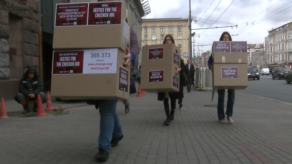 Gay rights activists carry empty boxes to the prosecutor general's office.