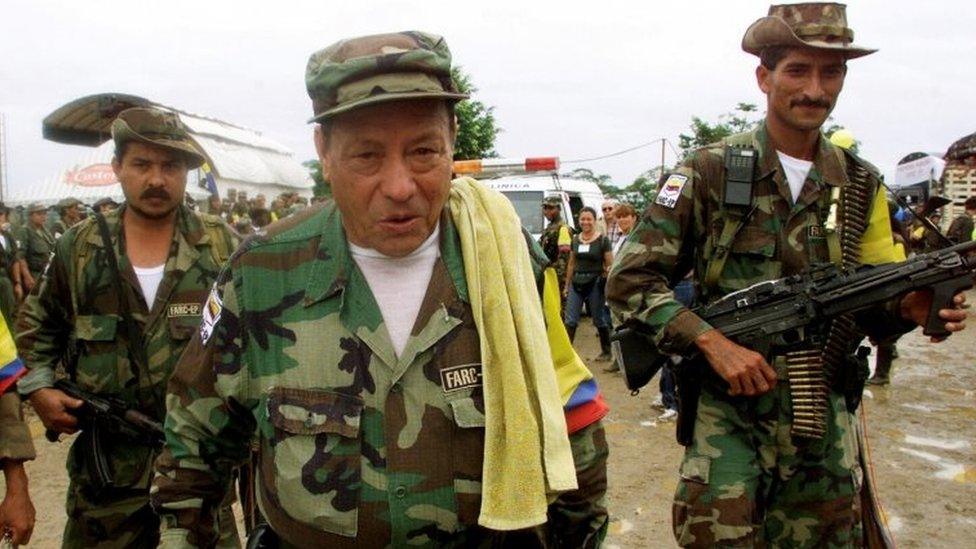 Manuel "Sureshot" Marulanda Velez (C) of the Revolutionary Armed Forces of Colombia (FARC) walks in Villa Colombia camp near Caqueta province, Colombia, April 29, 2000