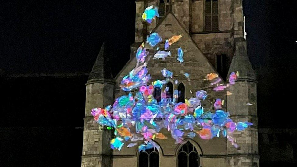 Shoal of fish projected onto Grimsby Minster