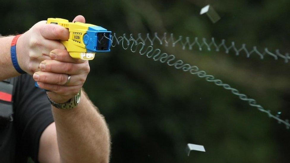 Close-up of a Taser gun being fired