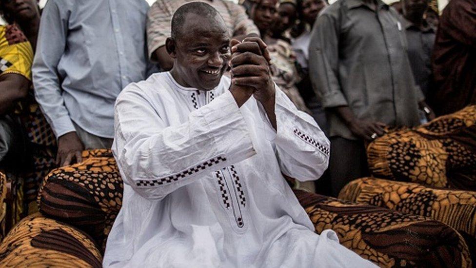 Adama Barrow, the flag-bearer of the coalition of the seven opposition political parties in Gambia, greets supporters during a gathering in the buffer Zone district of Talinding on November 29, 2016 on the last day of the presidential campaign in Gambia.