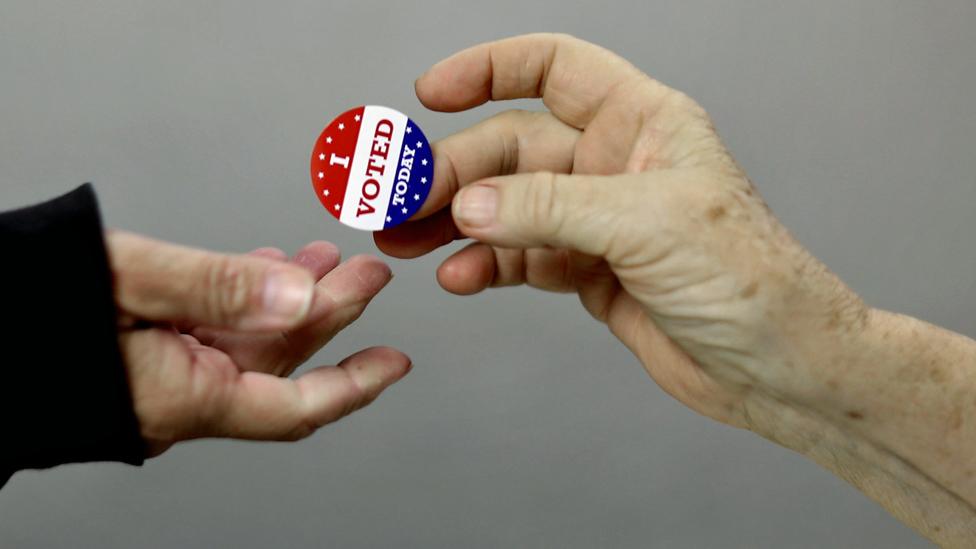 Voters get an 'I Voted Today' sticker after casting their ballots on election day at the Red Oak Fire Department in Red Oak, Iowa - 4 November 2014