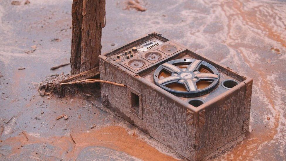 Speakers are half buried in the mud in Bento Rodrigues