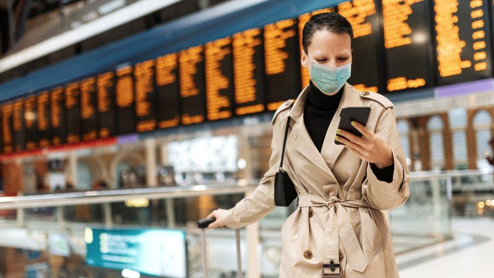 Business traveller looking at her phone