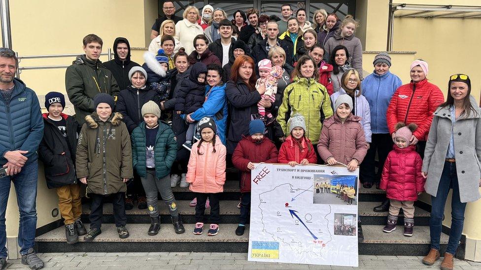 Volunteers and refugees outside the Park Hotel