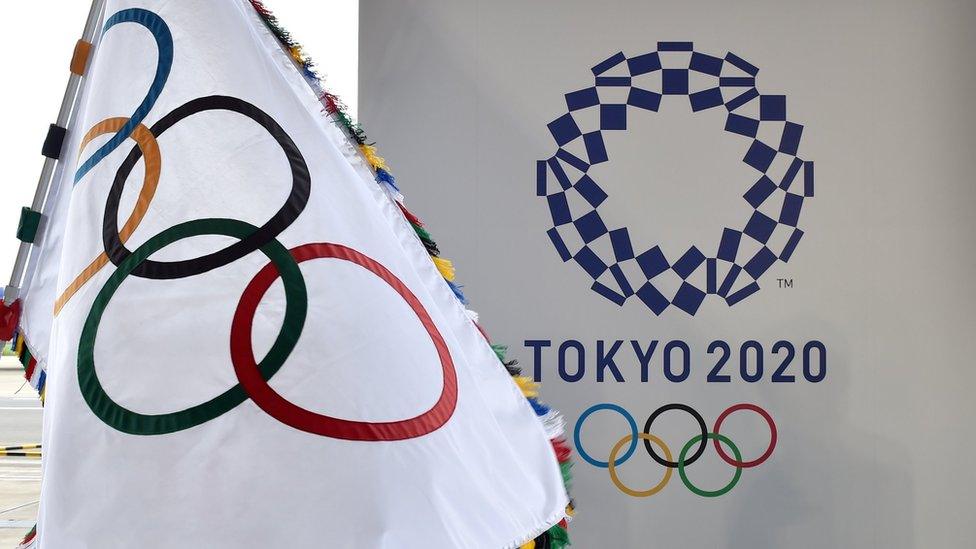 An Olympic Flag pictured next to the Tokyo 2020 logo