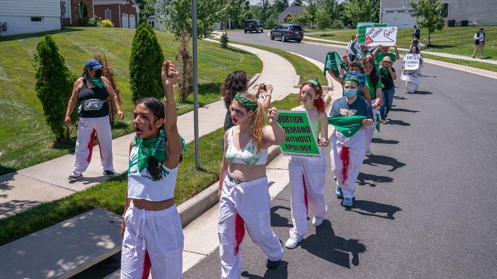 Abortion rights activists march near the home of Supreme Court Justice Amy Coney Barrett on 18 June 2022 in Falls Church, Virginia