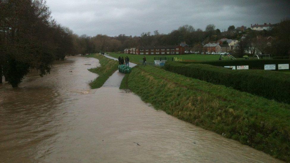 River levels are high in Llanelwy, St Asaph, where extra flood defences have been deployed