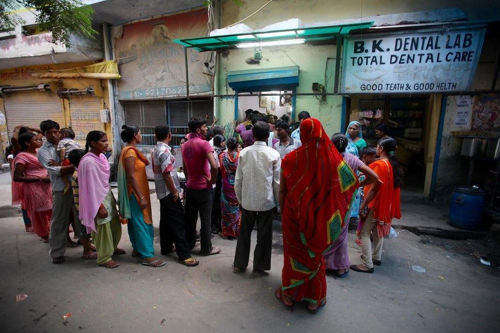 People queue outside a private doctor's clinic in Karkardooma