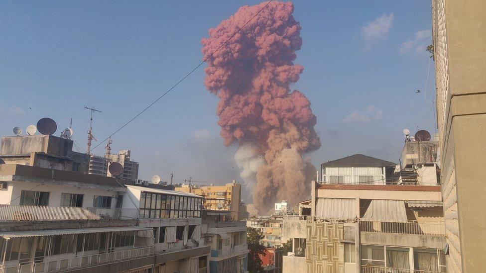 A huge cloud of smoke rising up from the site of the explosion