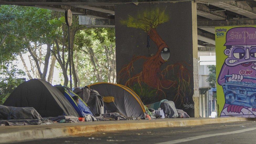 Homeless people sheltering under an elevated highway in São Paulo